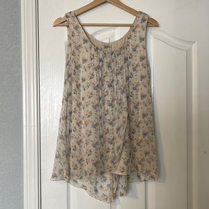Small blouse with flower detail. Sheer with undershirt built in.